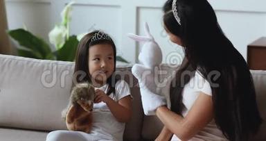 快乐的亚洲妈妈和女儿玩木偶玩具